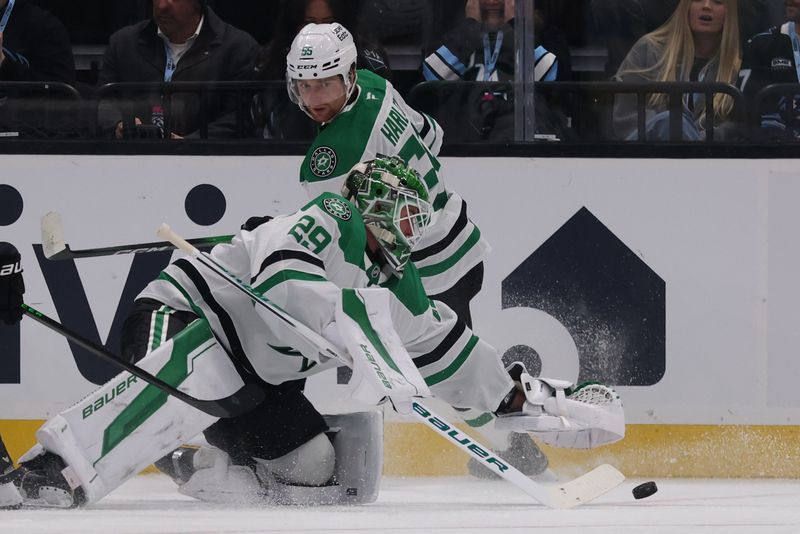 Jan 15, 2026; Salt Lake City, Utah, USA; Dallas Stars goaltender Jake Oettinger (29) goes for the puck during the first period of a game against the Utah Mammoth at Delta Center. Mandatory Credit: Rob Gray-Imagn Images