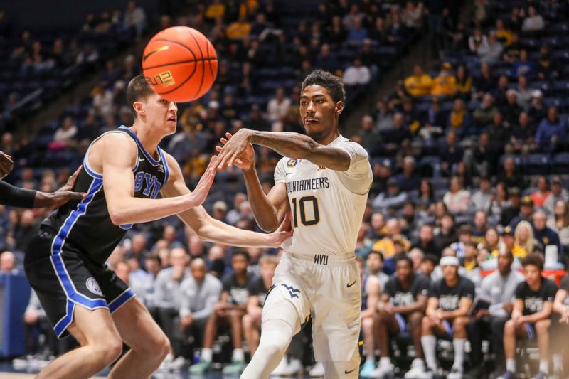 Feb 11, 2025; Morgantown, West Virginia, USA; West Virginia Mountaineers guard Sencire Harris (10) passes the ball during the first half against the Brigham Young Cougars at WVU Coliseum. Mandatory Credit: Ben Queen-Imagn Images