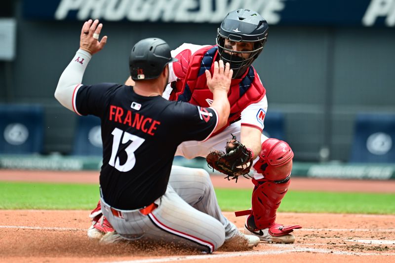 May 1, 2025; Cleveland, Ohio, USA; Cleveland Guardians catcher Austin Hedges (27) tags out Minnesota Twins first baseman Ty France (13) during the second inning at Progressive Field. Mandatory Credit: Ken Blaze-Imagn Images

