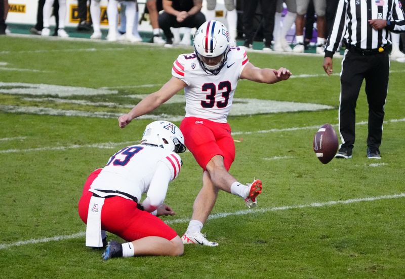 Nov 11, 2023; Boulder, Colorado, USA; Arizona Wildcats place kicker Tyler Loop (33) kicks the winning field goal in the fourth quarter against the Colorado Buffaloes at Folsom Field. Mandatory Credit: Ron Chenoy-USA TODAY Sports