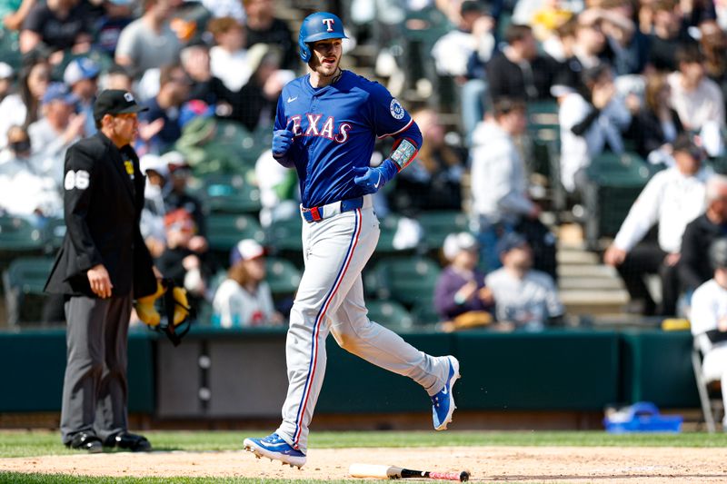 May 24, 2025; Chicago, Illinois, USA; Texas Rangers catcher Jonah Heim (28) scores against the Chicago White Sox during the fourth inning at Rate Field. Mandatory Credit: Kamil Krzaczynski-Imagn Images
