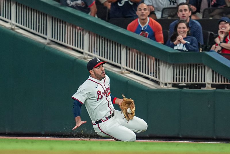 Aug 20, 2024; Cumberland, Georgia, USA; Atlanta Braves right fielder Ramon Laureano (18) makes a sliding catch on a ball hit by Philadelphia Phillies right fielder Nick Castellanos (8) (not shown) during the ninth inning at Truist Park. Mandatory Credit: Dale Zanine-USA TODAY Sports