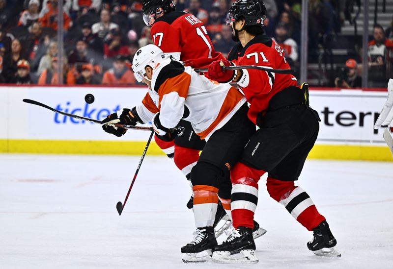 Apr 13, 2024; Philadelphia, Pennsylvania, USA; Philadelphia Flyers right wing Cam Atkinson (89) reaches to deflect a shot between New Jersey Devils defenseman Simon Nemec (17) and defenseman Jonas Siegenthaler (71) in the first period at Wells Fargo Center. Mandatory Credit: Kyle Ross-USA TODAY Sports