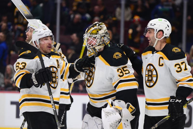 Feb 25, 2023; Vancouver, British Columbia, CAN; Boston Bruins goaltender Linus Ullmark (35) celebrates his empty net goal during the third period at Rogers Arena. Mandatory Credit: Anne-Marie Sorvin-USA TODAY Sports