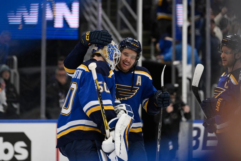 Apr 27, 2025; St. Louis, Missouri, USA; St. Louis Blues center Robert Thomas (18) and goaltender Jordan Binnington (50) celebrate defeating the Winnipeg Jets in game four of the first round of the 2025 Stanley Cup Playoffs at Enterprise Center. Mandatory Credit: Jeff Le-Imagn Images