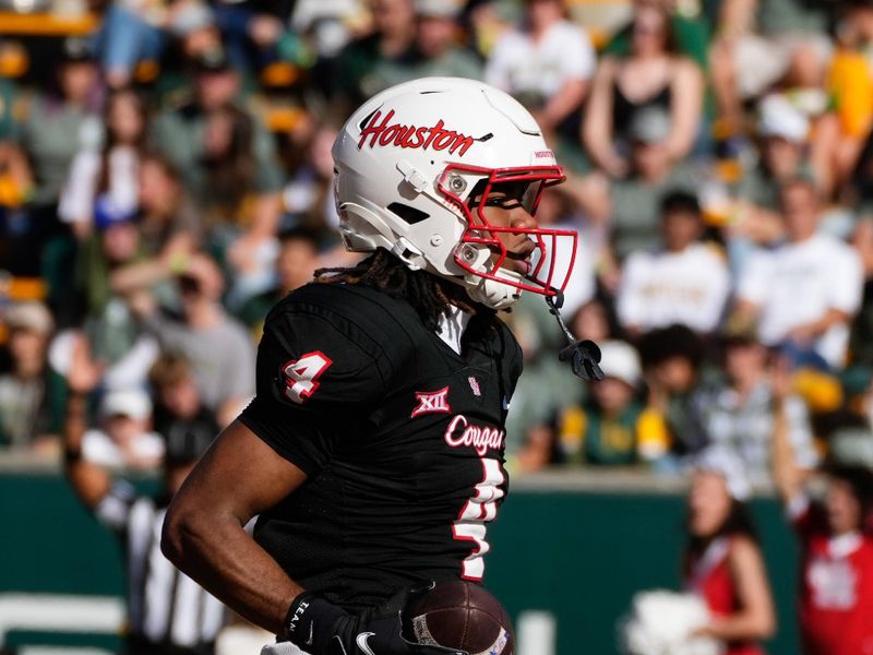 Nov 4, 2023; Waco, Texas, USA;  Houston Cougars wide receiver Samuel Brown (4) celebrates after catching a touchdown pass against Baylor Bears cornerback Chateau Reed (21) during the first half at McLane Stadium. Mandatory Credit: Chris Jones-USA TODAY Sports