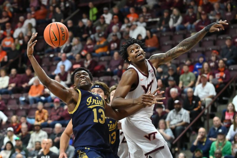 Jan 17, 2026; Blacksburg, Virginia, USA;  Notre Dame Fighting Irish guard Sir Mohammed (13) and Virginia Tech Hokies forward Amani Hansberry (13) battle for a rebound during the first half at Cassell Coliseum. Mandatory Credit: Brian Bishop-Imagn Images