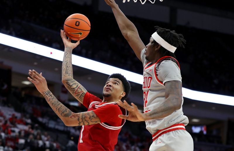 Feb 6, 2024; Columbus, Ohio, USA; Indiana Hoosiers center Kel'el Ware (1) shoots as Ohio State Buckeyes center Felix Okpara (34) defends during the first half at Value City Arena. Mandatory Credit: Joseph Maiorana-USA TODAY Sports