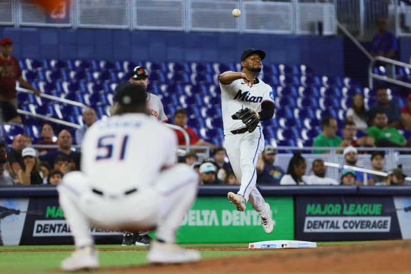 Apr 17, 2024; Miami, Florida, USA; Miami Marlins shortstop Otto Lopez (61) throws to first base is unable retire San Francisco Giants second baseman Thairo Estrada (not pictured) during the seventh inning at loanDepot Park. Mandatory Credit: Sam Navarro-USA TODAY Sports