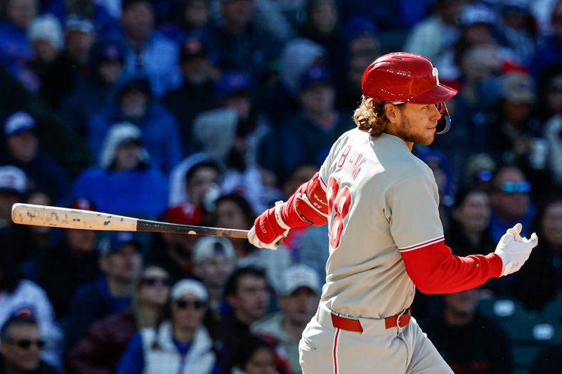 Apr 26, 2025; Chicago, Illinois, USA; Philadelphia Phillies third baseman Alec Bohm (28) hits an RBI-single against the Chicago Cubs during the fourth inning at Wrigley Field. Mandatory Credit: Kamil Krzaczynski-Imagn Images