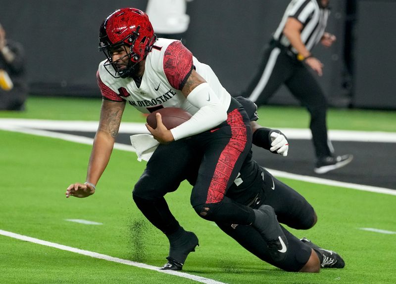 Nov 19, 2021; Paradise, Nevada, USA; San Diego State Aztecs quarterback Lucas Johnson (7) is sacked by UNLV Rebels linebacker Jacoby Windmon (4) during a game at Allegiant Stadium. Mandatory Credit: Stephen R. Sylvanie-USA TODAY Sports