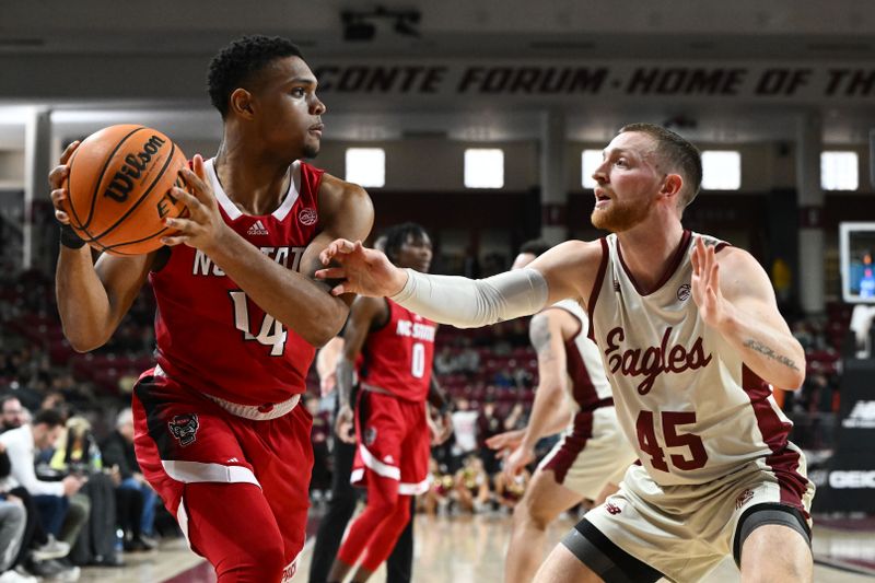 Feb 11, 2023; Chestnut Hill, Massachusetts, USA; North Carolina State Wolfpack guard Casey Morsell (14) controls the ball against Boston College Eagles guard Mason Madsen (45) during the first half at the Conte Forum. Mandatory Credit: Brian Fluharty-USA TODAY Sports