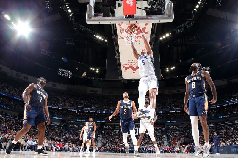 NEW ORLEANS, LA - APRIL 3:  Paolo Banchero #5 of the Orlando Magic dunks the ball during the game against the New Orleans Pelicans on April 3, 2024 at the Smoothie King Center in New Orleans, Louisiana. NOTE TO USER: User expressly acknowledges and agrees that, by downloading and or using this Photograph, user is consenting to the terms and conditions of the Getty Images License Agreement. Mandatory Copyright Notice: Copyright 2024 NBAE (Photo by Layne Murdoch Jr./NBAE via Getty Images)