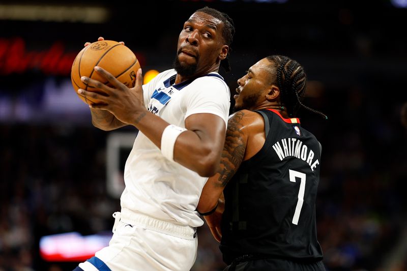 MINNEAPOLIS, MINNESOTA - FEBRUARY 04: Naz Reid #11 of the Minnesota Timberwolves goes to the basket against Cam Whitmore #7 of the Houston Rockets in the fourth quarter at Target Center on February 04, 2024 in Minneapolis, Minnesota. The Timberwolves defeated the Rockets 111-90. NOTE TO USER: User expressly acknowledges and agrees that, by downloading and or using this photograph, User is consenting to the terms and conditions of the Getty Images License Agreement. (Photo by David Berding/Getty Images)