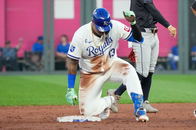 Sep 4, 2024; Kansas City, Missouri, USA; Kansas City Royals first baseman Salvador Perez (13) celebrates against the Cleveland Guardians at second base after hitting a double in the third inning at Kauffman Stadium. Mandatory Credit: Denny Medley-Imagn Images