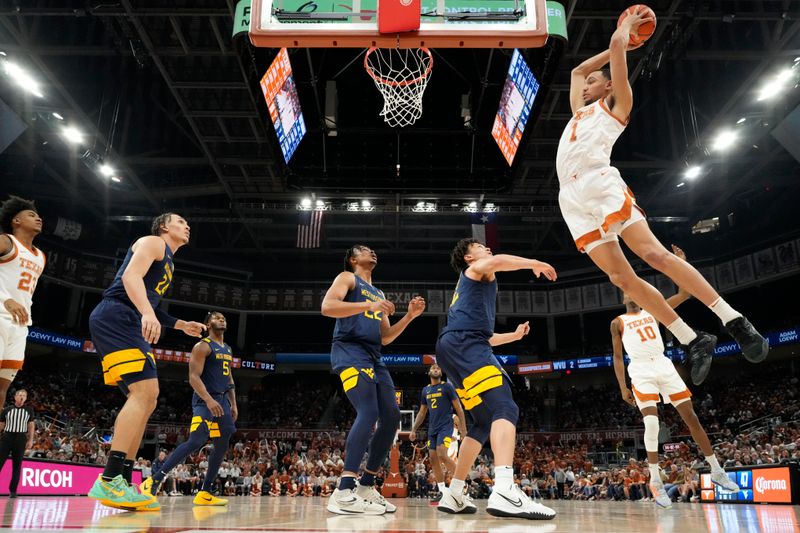 Feb 11, 2023; Austin, Texas, USA; Texas Longhorns forward Dylan Disu (1) grabs a rebound during the second half against the West Virginia Mountaineers at Moody Center. Mandatory Credit: Scott Wachter-USA TODAY Sports ac