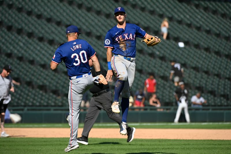 Aug 29, 2024; Chicago, Illinois, USA;  Texas Rangers first baseman Nathaniel Lowe (30) and third baseman Josh Jung (6) celebrate after the game against the Chicago White Sox at Guaranteed Rate Field. Mandatory Credit: Matt Marton-USA TODAY Sports