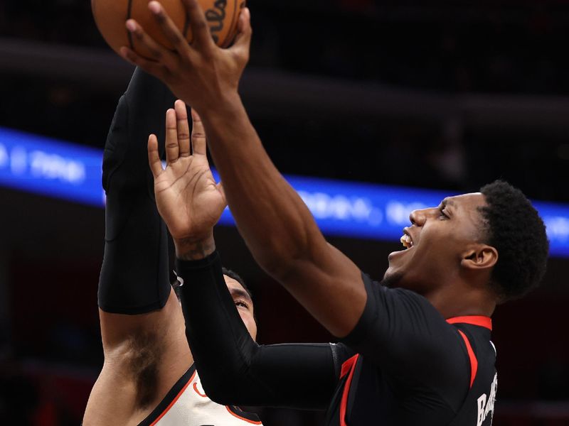 DETROIT, MICHIGAN - NOVEMBER 25: RJ Barrett #9 of the Toronto Raptors drives to the basket against Tobias Harris #12 of the Detroit Pistons during the second half at Little Caesars Arena on November 25, 2024 in Detroit, Michigan. Detroit won the game 102-100. NOTE TO USER: User expressly acknowledges and agrees that, by downloading and or using this photograph, User is consenting to the terms and conditions of the Getty Images License. (Photo by Gregory Shamus/Getty Images)