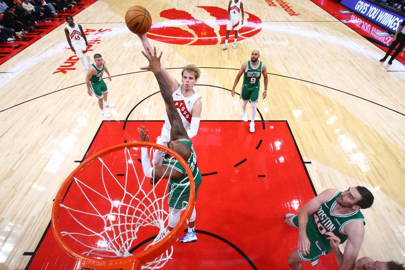 TORONTO, CANADA - OCTOBER 15: Gradey Dick #1 of the Toronto Raptors drives to the basket during the game against the Boston Celtics on October 15, 2024 at the Scotiabank Arena in Toronto, Ontario, Canada.  NOTE TO USER: User expressly acknowledges and agrees that, by downloading and or using this Photograph, user is consenting to the terms and conditions of the Getty Images License Agreement.  Mandatory Copyright Notice: Copyright 2024 NBAE (Photo by Vaughn Ridley/NBAE via Getty Images)