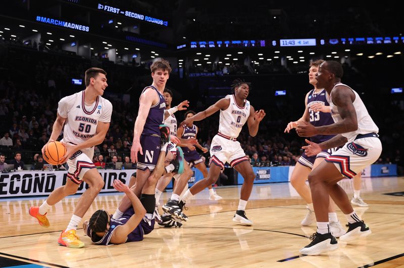 March 22, 2024, Brooklyn, NY, USA; Florida Atlantic Owls center Vladislav Goldin (50) rebounds the ball against the Northwestern Wildcats in the first round of the 2024 NCAA Tournament at the Barclays Center. Mandatory Credit: Brad Penner-USA TODAY Sports