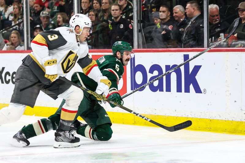 Apr 3, 2023; Saint Paul, Minnesota, USA; Minnesota Wild defenseman Jake Middleton (5) and Vegas Golden Knights defenseman Brayden McNabb (3) battle for the puck during the second period at Xcel Energy Center. Mandatory Credit: Matt Krohn-USA TODAY Sports