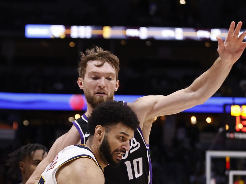 DENVER, COLORADO - FEBRUARY 28: Jamal Murray #27 of the Denver Nuggets drives against Domantas Sabonis #10 of the Sacramento Kings at Ball Arena on February 28, 2024 in Denver, Colorado. NOTE TO USER: User expressly acknowledges and agrees that, by downloading and or using this photograph, User is consenting to the terms and conditions of the Getty Images License Agreement. (Photo by Brendall O'Banon/Clarkson Creative/Getty Images)