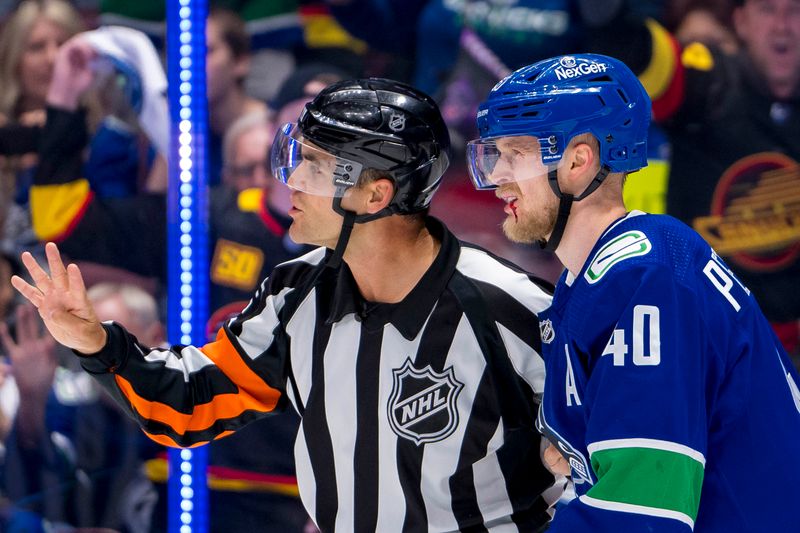May 20, 2024; Vancouver, British Columbia, CAN; The referee and Vancouver Canucks forward Elias Pettersson (40) reacts after Pettersson was hit in the mouth with a high stick against the Edmonton Oilers during the first period in game seven of the second round of the 2024 Stanley Cup Playoffs at Rogers Arena. Mandatory Credit: Bob Frid-USA TODAY Sports