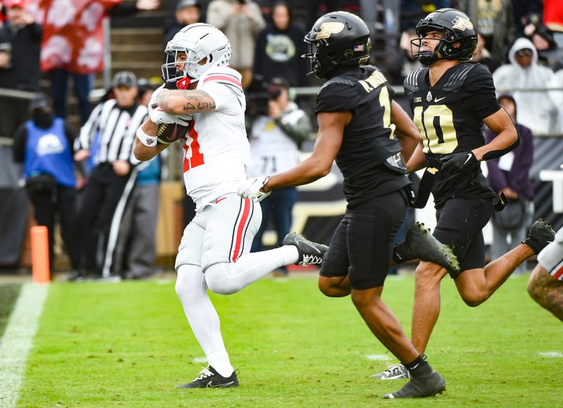 Oct 14, 2023; West Lafayette, Indiana, USA;  Ohio State Buckeyes wide receiver Brandon Inniss (11) runs a catch in for a touchdown past Purdue Boilermakers defensive back Cam Allen (10) during the second half at Ross-Ade Stadium. Mandatory Credit: Robert Goddin-USA TODAY Sports