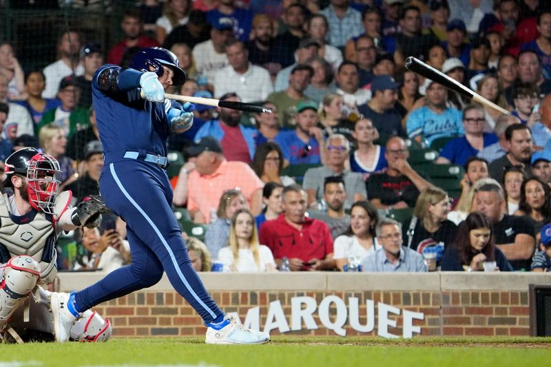 Jul 14, 2023; Chicago, Illinois, USA; Chicago Cubs left fielder Ian Happ (8) breaks his bat as he flies out to center field against the Boston Red Sox during the sixth inning at Wrigley Field. Mandatory Credit: David Banks-USA TODAY Sports