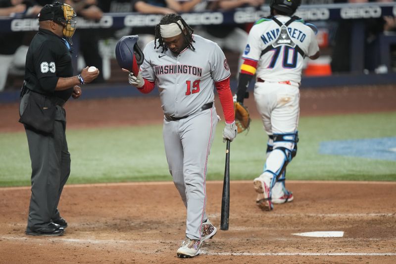 Sep 11, 2025; Miami, Florida, USA;  Washington Nationals first baseman Josh Bell (19) walks back to the dugout after striking out looking while pinch-hitting in the eighth inning against the Miami Marlins at loanDepot Park. Mandatory Credit: Jim Rassol-Imagn Images