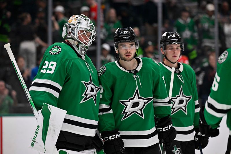 Oct 26, 2024; Dallas, Texas, USA; Dallas Stars goaltender Jake Oettinger (29) and center Mavrik Bourque (22) and defenseman Nils Lundkvist (5) celebrate on the ice after the Stars defeat the Chicago Blackhawks at the American Airlines Center. Mandatory Credit: Jerome Miron-Imagn Images