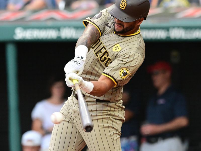 Jul 20, 2024; Cleveland, Ohio, USA; San Diego Padres right fielder David Peralta (24) hits a single during the second inning against the Cleveland Guardians at Progressive Field. Mandatory Credit: Ken Blaze-USA TODAY Sports