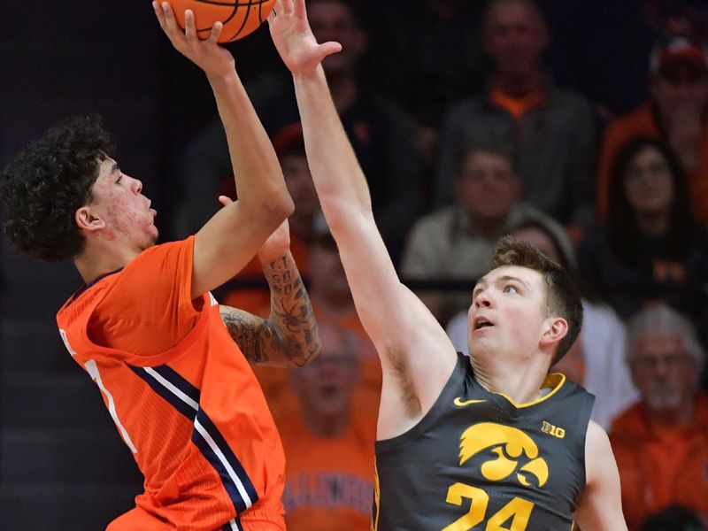 Feb 25, 2025; Champaign, Illinois, USA;  Iowa Hawkeyes forward Pryce Sandfort (24) attempts to block the shot of Illinois Fighting Illini forward Will Riley (7) during the second half at State Farm Center. Mandatory Credit: Ron Johnson-Imagn Images