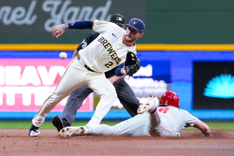 Sep 17, 2024; Milwaukee, Wisconsin, USA;  Philadelphia Phillies left fielder Brandon Marsh (16) steals second base as Milwaukee Brewers second baseman Brice Turang (2) waits for the throw during the second inning at American Family Field. Mandatory Credit: Jeff Hanisch-Imagn Images