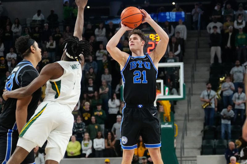 Jan 9, 2024; Waco, Texas, USA;  Brigham Young Cougars guard Trevin Knell (21) scores a three point basket against Baylor Bears guard Ja'Kobe Walter (4) during the first half at Paul and Alejandra Foster Pavilion. Mandatory Credit: Chris Jones-USA TODAY Sports