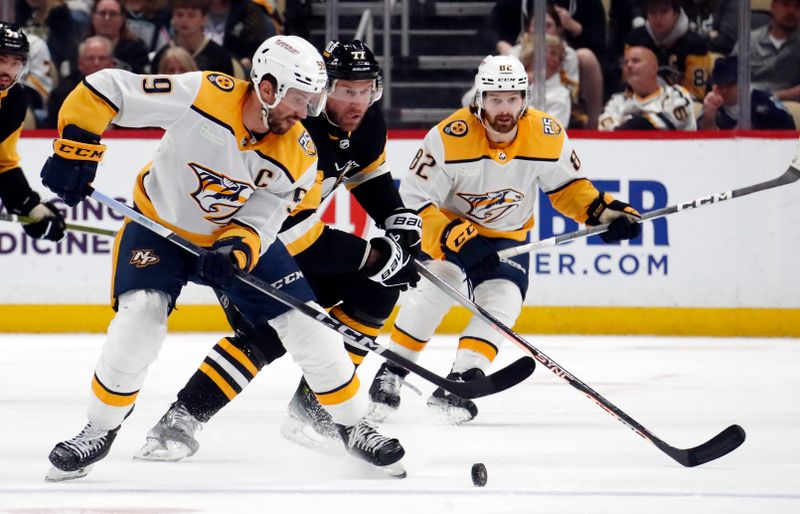 Apr 15, 2024; Pittsburgh, Pennsylvania, USA;  Nashville Predators left wing Filip Forsberg (9) moves the puck against Pittsburgh Penguins center Jeff Carter (77) during the third period at PPG Paints Arena. The Penguins won 4-2. Mandatory Credit: Charles LeClaire-USA TODAY Sports