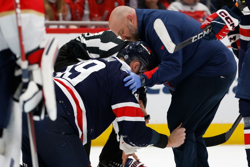 Nov 8, 2023; Washington, District of Columbia, USA; Washington Capitals right wing Anthony Mantha (39) is attended to by Capitals head trainer Jason Serbus (R) after being hit in the head with the puck against the Florida Panthers in the third period at Capital One Arena. Mandatory Credit: Geoff Burke-USA TODAY Sports