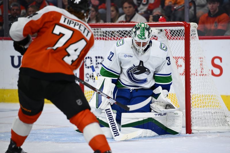 Oct 19, 2024; Philadelphia, Pennsylvania, USA; Vancouver Canucks goalie Kevin Lankinen (32) defends a shot from Philadelphia Flyers right wing Owen Tippett (74) in the second period at Wells Fargo Center. Mandatory Credit: Kyle Ross-Imagn Images