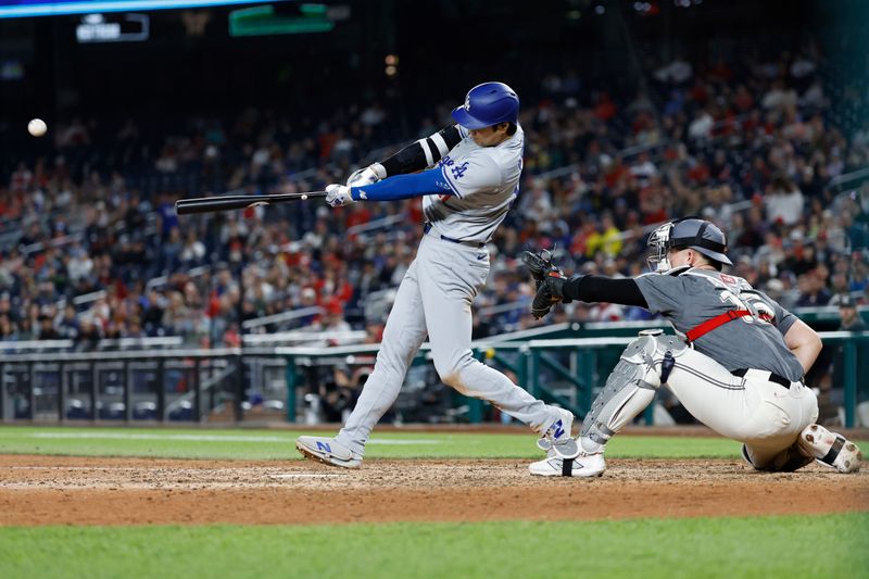 Apr 23, 2024; Washington, District of Columbia, USA; Los Angeles Dodgers designated hitter Shohei Ohtani (17) hits a solo home run against the Washington Nationals during the ninth inning at Nationals Park. Mandatory Credit: Geoff Burke-USA TODAY Sports