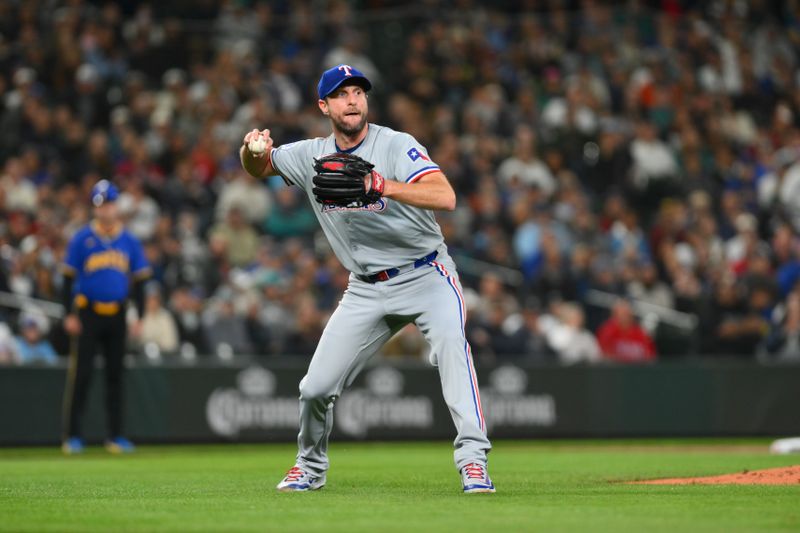 Sep 14, 2024; Seattle, Washington, USA; Texas Rangers starting pitcher Max Scherzer (31) throws the ball to first base for a force out against the Seattle Mariners during the second inning at T-Mobile Park. Mandatory Credit: Steven Bisig-Imagn Images