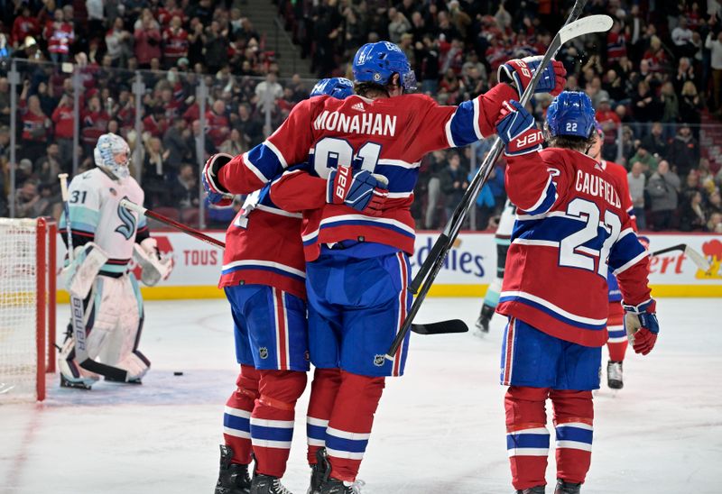 Dec 4, 2023; Montreal, Quebec, CAN; Montreal Canadiens forward Sean Monahan (91) celebrates with teammates including forward Cole Caufield (22) and forward Nick Suzuki (14) after scoring a goal against Seattle Kraken goalie Philipp Grubauer (31) during the second period at the Bell Centre. Mandatory Credit: Eric Bolte-USA TODAY Sports