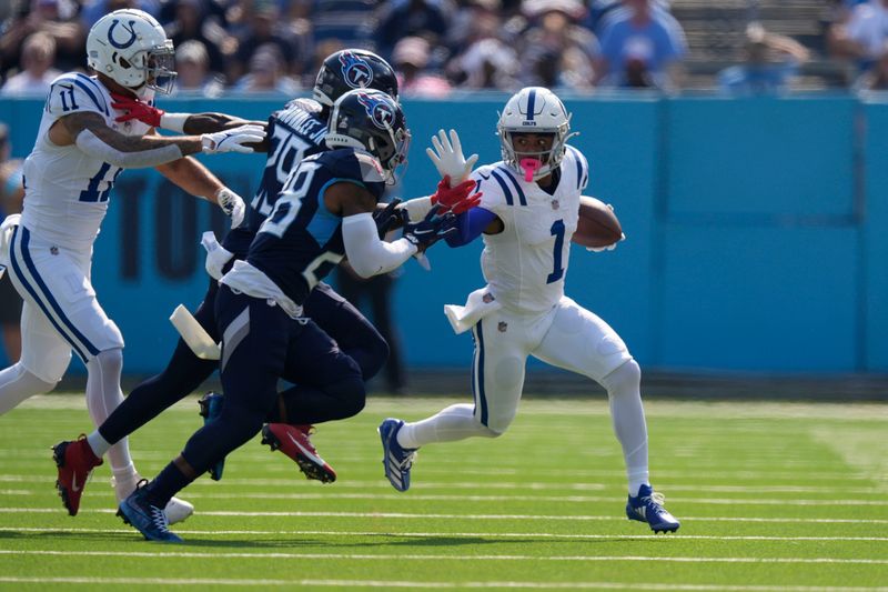 Indianapolis Colts wide receiver Josh Downs (1) runs past Tennessee Titans safety Quandre Diggs (28) during the first half of an NFL football game, Sunday, Oct. 13, 2024, in Nashville, Tenn. (AP Photo/George Walker IV)