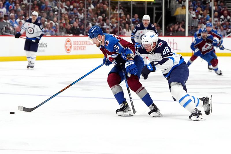 Apr 28, 2024; Denver, Colorado, USA; Winnipeg Jets defenseman Nate Schmidt (88) defends on Colorado Avalanche right wing Valeri Nichushkin (13) during the second period in game four of the first round of the 2024 Stanley Cup Playoffs at Ball Arena. Mandatory Credit: Ron Chenoy-USA TODAY Sports