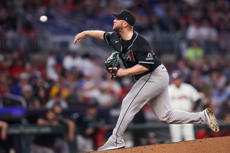 Jun 4, 2025; Atlanta, Georgia, USA; Arizona Diamondbacks starting pitcher Merrill Kelly (29) throws against the Atlanta Braves in the fourth inning at Truist Park. Mandatory Credit: Brett Davis-Imagn Images