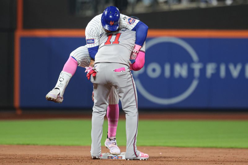 May 12, 2024; New York City, New York, USA; New York Mets shortstop Francisco Lindor (12) reacts after a double during the sixth inning as Atlanta Braves shortstop Orlando Arcia (11) tags at Citi Field. Mandatory Credit: Vincent Carchietta-USA TODAY Sports