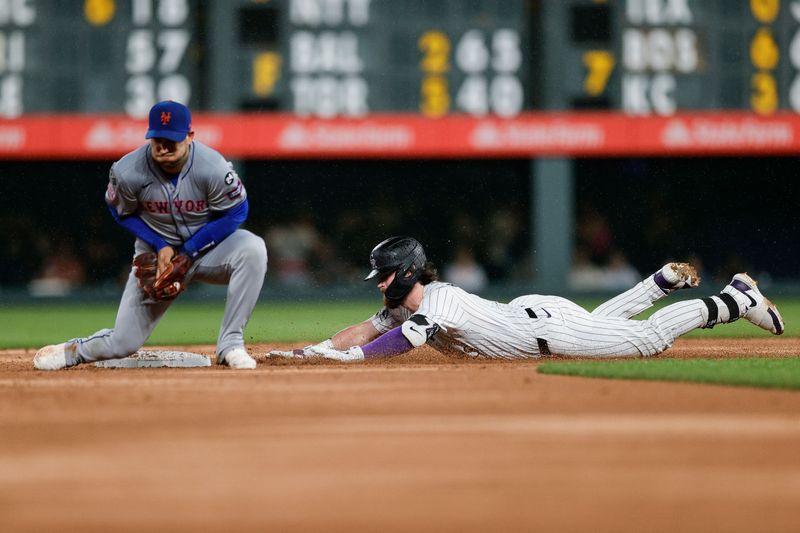Aug 6, 2024; Denver, Colorado, USA; Colorado Rockies second baseman Brendan Rodgers (7) slides safely into second against New York Mets second baseman Jose Iglesias (11) in the fifth inning at Coors Field. Mandatory Credit: Isaiah J. Downing-USA TODAY Sports