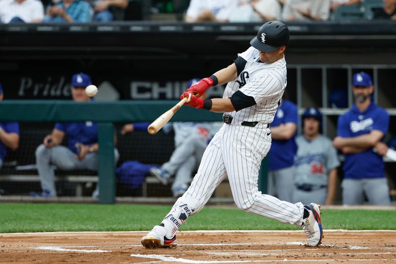 Jun 25, 2024; Chicago, Illinois, USA; Chicago White Sox outfielder Andrew Benintendi (23) hits a two-run home run against the Los Angeles Dodgers during the first inning at Guaranteed Rate Field. Mandatory Credit: Kamil Krzaczynski-USA TODAY Sports