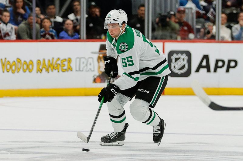 Oct 11, 2025; Denver, Colorado, USA; Dallas Stars defenseman Thomas Harley (55) controls the puck in the first period against the Colorado Avalanche at Ball Arena. Mandatory Credit: Isaiah J. Downing-Imagn Images
