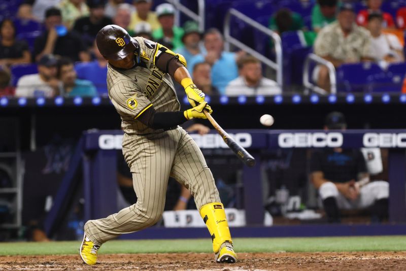 Aug 11, 2024; Miami, Florida, USA; San Diego Padres pinch-hitter Donovan Solano (39) hits a two-run home run against the Miami Marlins during the eighth inning at loanDepot Park. Mandatory Credit: Sam Navarro-USA TODAY Sports