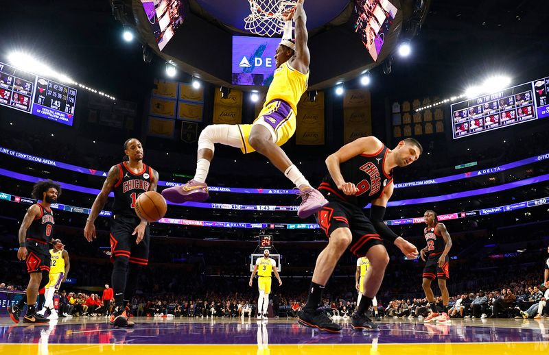 LOS ANGELES, CALIFORNIA - JANUARY 25:  Jarred Vanderbilt #2 of the Los Angeles Lakers makes a slam dunk against Nikola Vucevic #9 of the Chicago Bulls in the second half at Crypto.com Arena on January 25, 2024 in Los Angeles, California.  NOTE TO USER: User expressly acknowledges and agrees that, by downloading and/or using this photograph, user is consenting to the terms and conditions of the Getty Images License Agreement.  (Photo by Ronald Martinez/Getty Images)